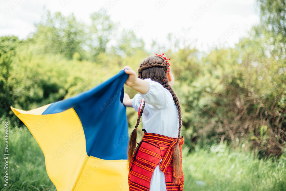 Ukraines Independence Flag Day. Constitution day. Ukrainian child girl in embroidered shirt vyshyvanka with yellow and blue flag of Ukraine in field. flag symbols of Ukraine. Kyiv, Kiev day