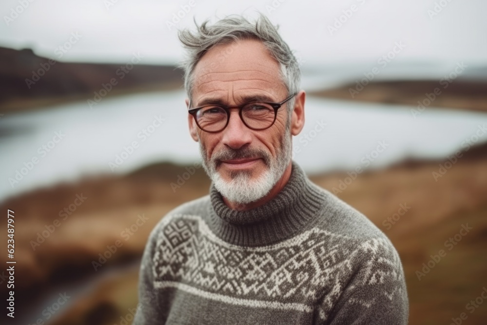 Photography in the style of pensive portraiture of a joyful mature man wearing a cozy sweater against a picturesque countryside background. With generative AI technology Photography in the style of pensive portraiture of a joyful mature man wearing a cozy sweater against a picturesque countryside background. With generative AI technology
