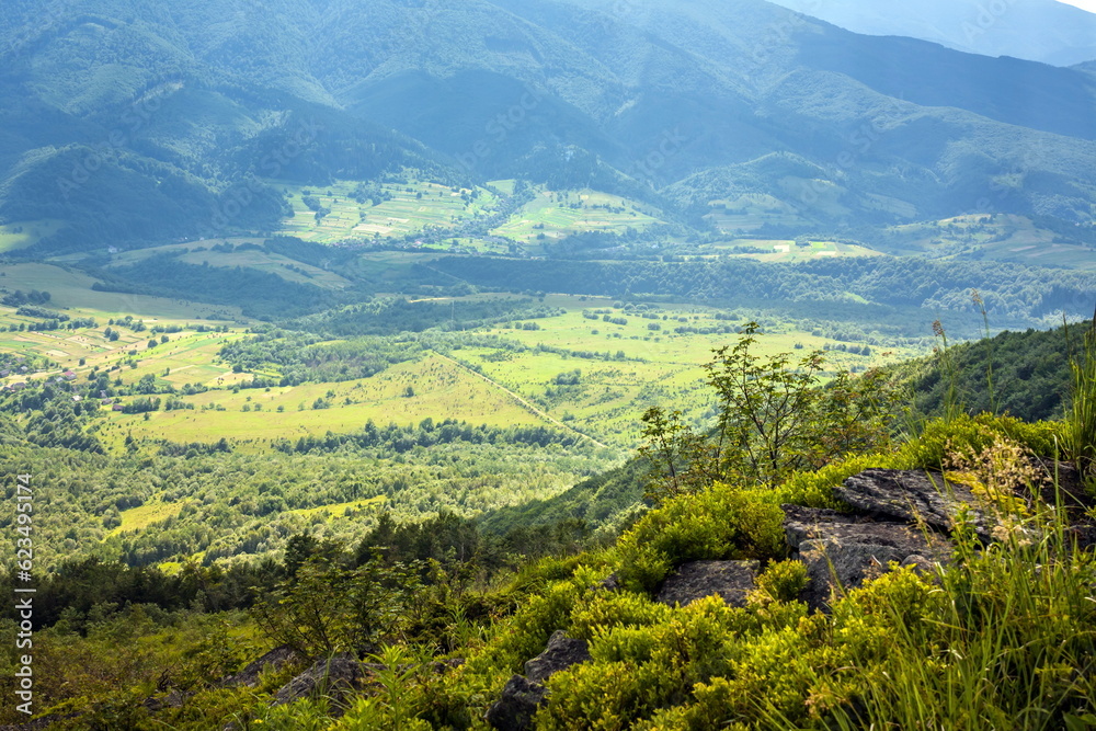 Beautiful view from the Ukrainian Polonynian Beskids to the mountains and valleys. Rocky peaks of the Ukrainian Carpathians in summer. Water-making ridge in the Carpathians, Carpathian mountains