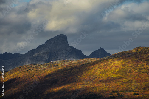 Dramatic light and clouds over mountain peaks of northern norway photo