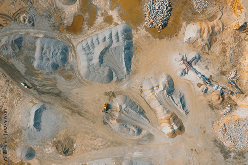 Pile of sand and rock or gravel in site, concrete plant in aerial view. Heap of aggregate or material from nature, mine or quarry for ready mix of cement, concrete. Builder using in construction.