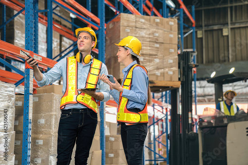 Caucasian man, woman warehouse supervisor discuss and use tablet check package with forklift driver worker load box on shelf, product distribution inventory management,Logistics shipping business plan © Dearix