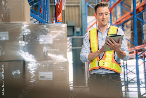 Smart smiling caucasian warehouse man,worker,manager use digital tablet to check goods on shelf for product distribution stock management, Logistics shipping business planning concept with copy space