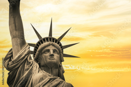 Looking up at the Statute of Liberty with a dramatic sky.