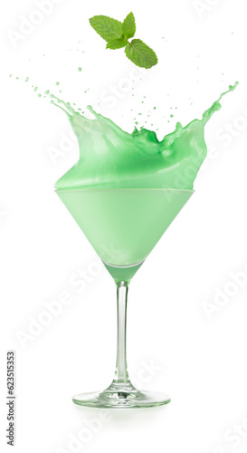 Mint leaf falling into a splattering grasshopper cocktail served in martini cup isolated on white background. Real shot.