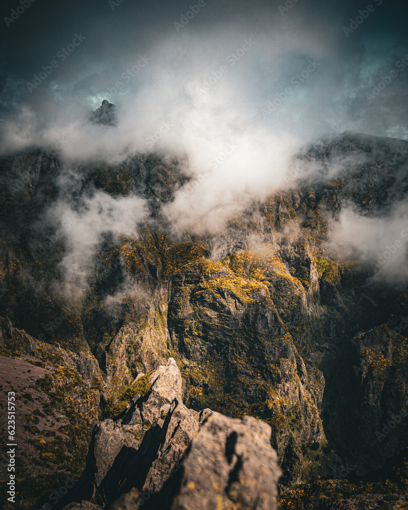 Pico do Arieiro, Madeira. Landscape photography with dramatic clouds and amazing rocks texture lighted by a sunbeam. moody edit