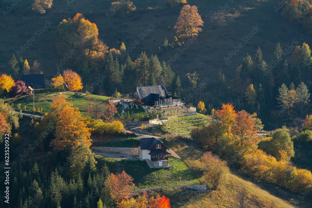 Autumn landscape with country houses in mountains