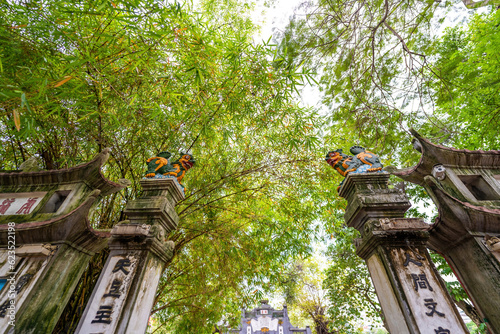 Entrance gate to the sacred Buddhist Ngoc Son Temple in Hoan Kiem Lake connected by The Huc Bridge to the bank of the lake of the center of Hanoi photo