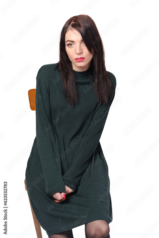 The girl looks aloofly to the side sitting on a chair. Isolate on a white background. Concept of depression, burnout, mental disorder. The girl looks aloofly to the side sitting on a chair. Isolate on a white background. Concept of depression, burnout, mental disorder.