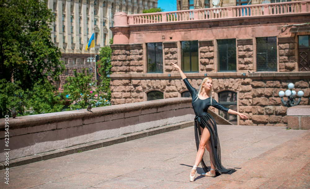 Young ballerina in ballet costume dancing and feeling breath of big ...