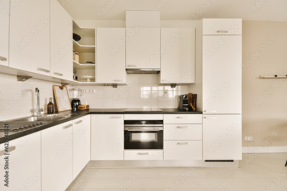 a kitchen with white cupboards and black counter tops on the counters in this is an example of modern design a kitchen with white cupboards and black counter tops on the counters in this is an example of modern design