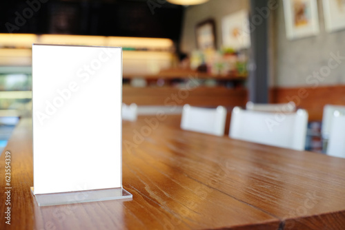 Mock up Menu frame standing on wood table in Bar restaurant cafe. space for text. © Charlie's