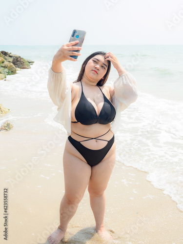 Photography Portrait young woman asian chubby cute beautiful taking pictures with smartphone