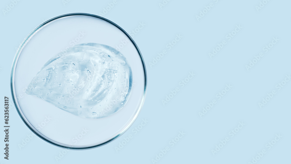 Petri dishes and drops and ointments of transparent gel or serum on a blue background. Banner with empty space for advertising. Petri dishes and drops and ointments of transparent gel or serum on a blue background. Banner with empty space for advertising.