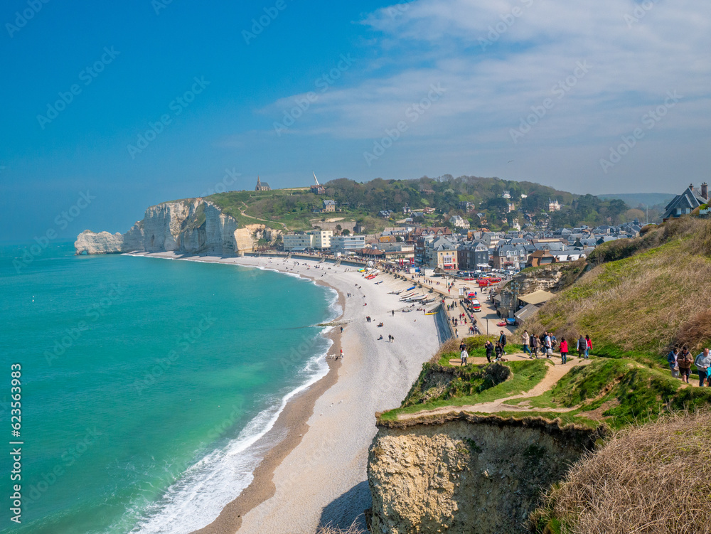 White cliffs of Etretat, Normandy, France,  with stunning view of the emerald sea ( the channel) and the blue sky in the background