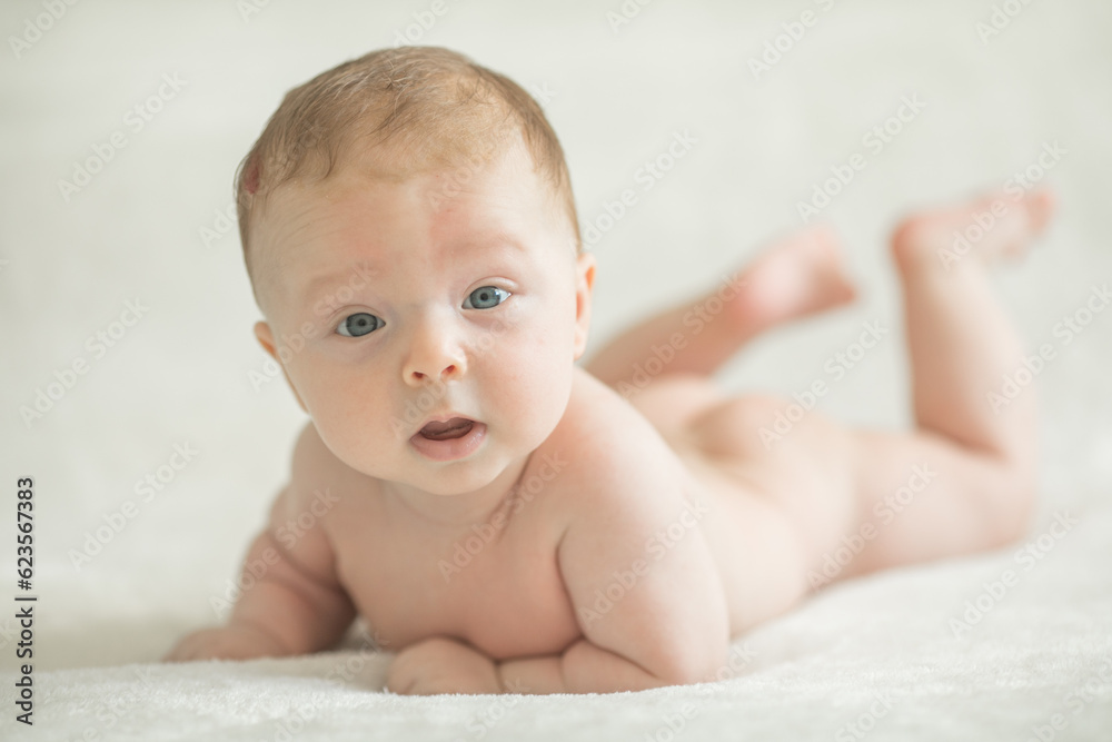 Baby boy crawling on bed. Little child playing in white sunny bedroom. Infant kid learning to crawl. Nursery for children. Textile, clothing and bedding for kids. Family morning at home. Baby boy crawling on bed. Little child playing in white sunny bedroom. Infant kid learning to crawl. Nursery for children. Textile, clothing and bedding for kids. Family morning at home.