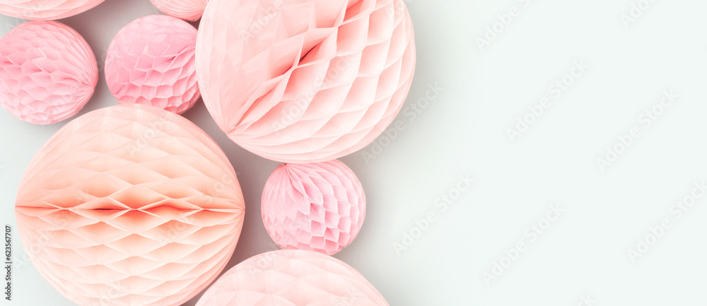 Banner with pink tissue paper balls on a blue background. Creative composition. Banner with pink tissue paper balls on a blue background. Creative composition.