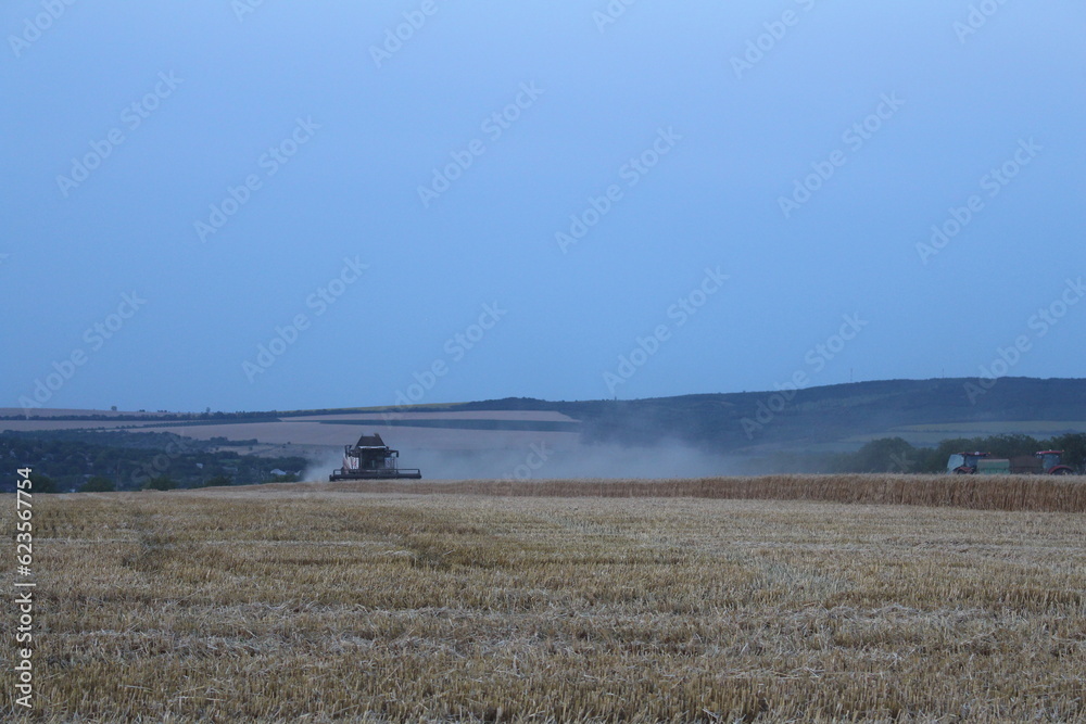 A large field with a tractor in it
