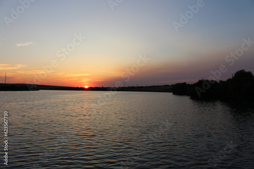 A sunset over a body of water © parpalac