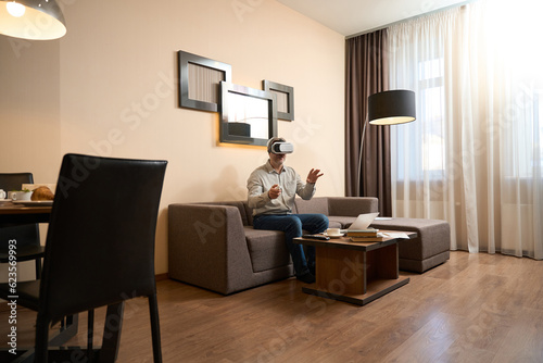 Adult man using virtual reality glasses in hotel room © Viacheslav Yakobchuk