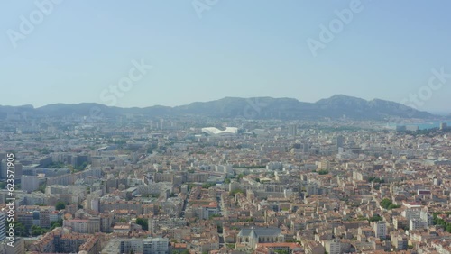 Aerial shot of Marseille in the sun with the velodrome and mountains in the distance, in France