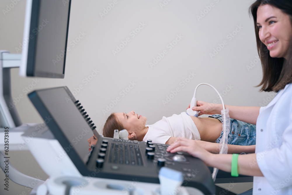 Cute child lies on a medical couch in ultrasound room Cute child lies on a medical couch in ultrasound room