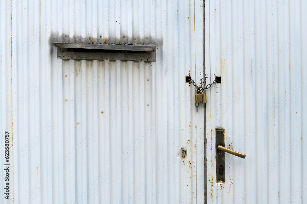 Old worn industrial metal gate with chain and padlock Old worn industrial metal gate with chain and padlock