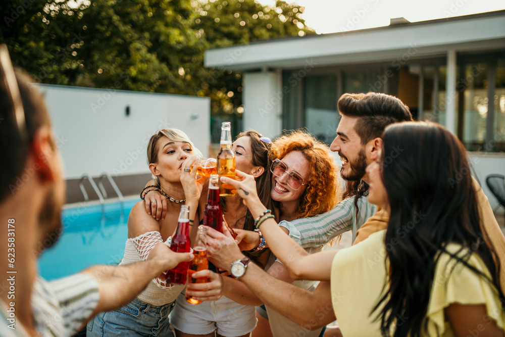 Poolside dancing, a group of friends groove to music near the pool, holding their cocktail bottles and dancing with infectious energy and joy. Poolside dancing, a group of friends groove to music near the pool, holding their cocktail bottles and dancing with infectious energy and joy.