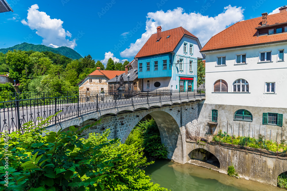 A view towards the fourteenth century Capuchin Bridge over the Selca Sora River in the town of Skofja Loka, Slovenia in summertime