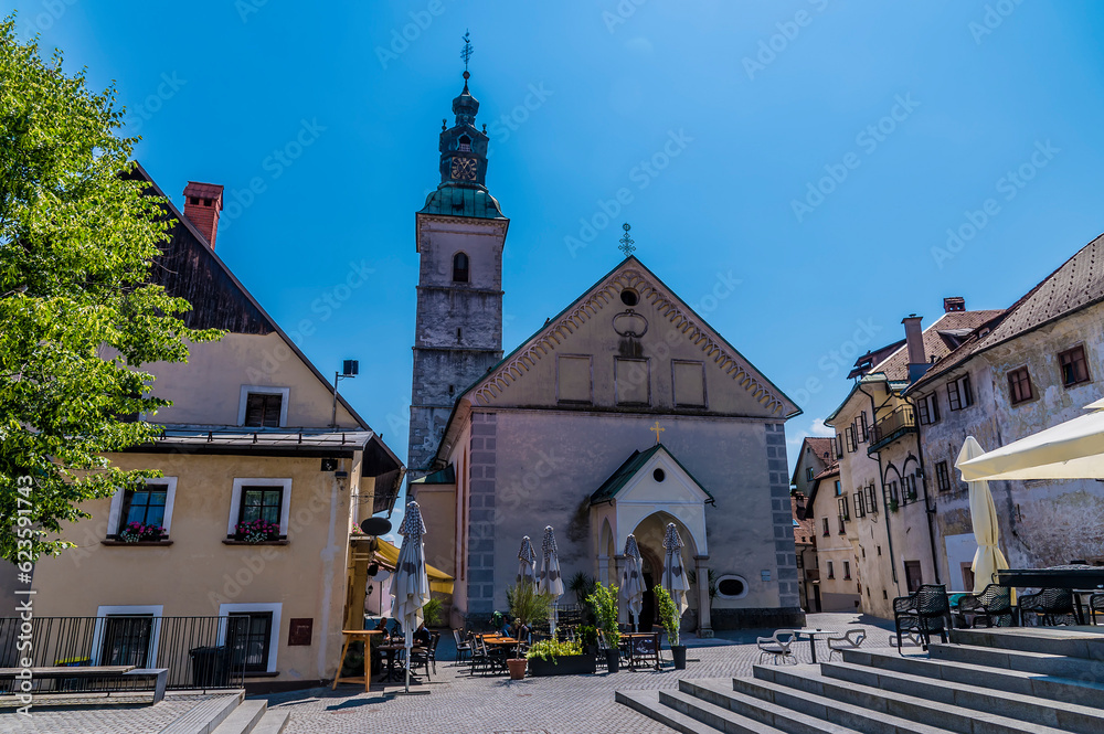 Fototapeta premium A view across the main square towards the cathedral in the town of Skofja Loka, Slovenia in summertime