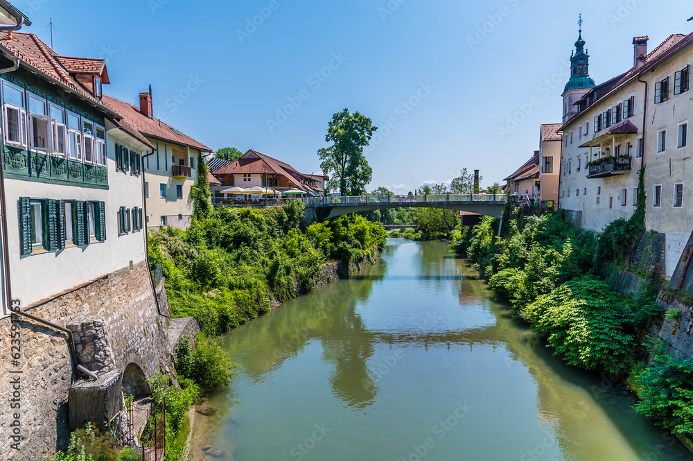 A view down the Selca Sora River from the Capuchin Bridge in the town of Skofja Loka, Slovenia in summertime