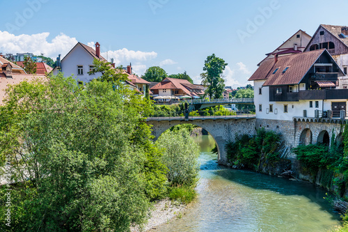 Fototapeta Naklejka Na Ścianę i Meble -  A view along the Selca Sora River in the town of Skofja Loka, Slovenia in summertime