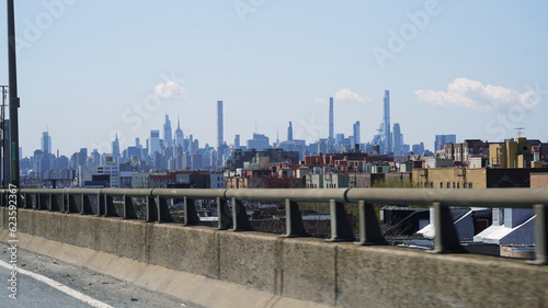 Car elevated highway in Bronx neighborhood with Manhattan, New York city skyscrapers in the distance © John Hanson Pye