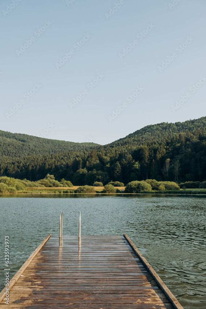 wooden pier lake surrounded by mountains, Slovenia. The concept of summer holidays, holidays