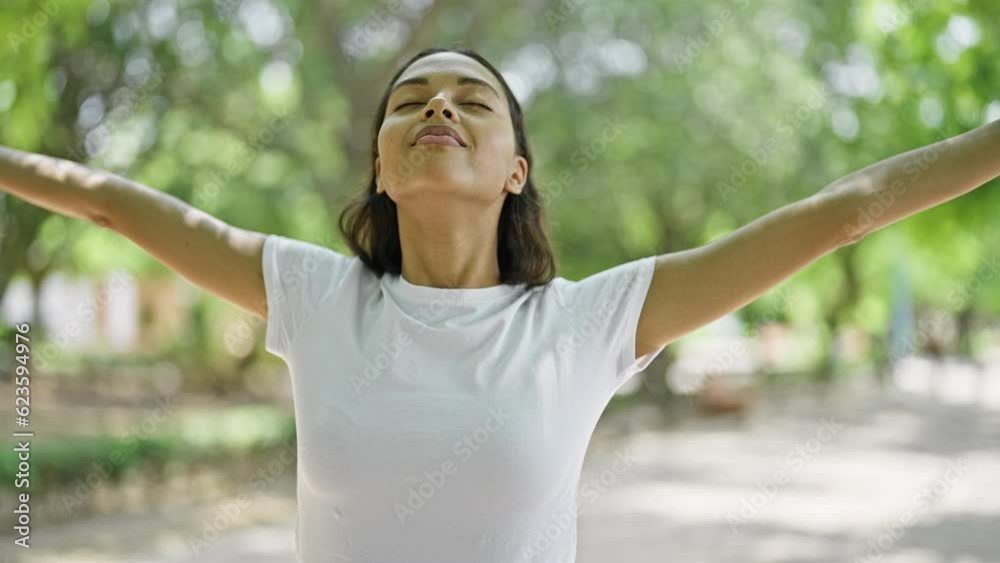 African american woman stretching arms breathing at park