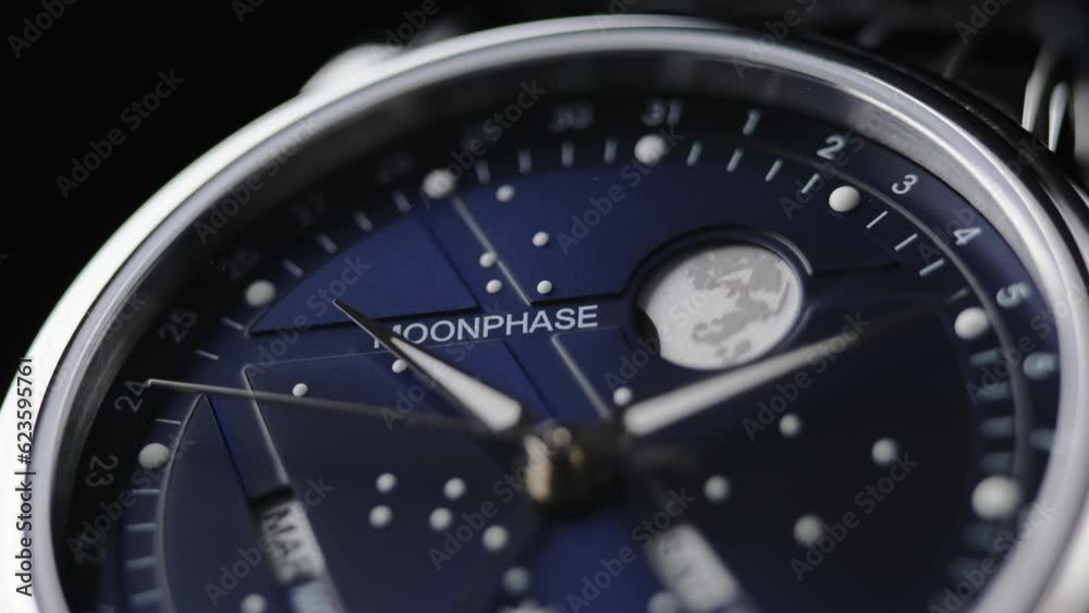 closeup view of rotating luxury swiss watch with moonphase and running second arrow. Macro. Watch with blue dial closeup view of rotating luxury swiss watch with moonphase and running second arrow. Macro. Watch with blue dial