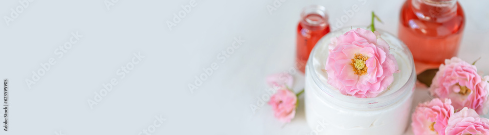 Premium skin care beauty treatment with pink rose petals. Plant-based pure organic ingredients in cosmetics. Jar of body or face moisturiser, lotion. Flower extract, natural youth anti-age elixir Premium skin care beauty treatment with pink rose petals. Plant-based pure organic ingredients in cosmetics. Jar of body or face moisturiser, lotion. Flower extract, natural youth anti-age elixir