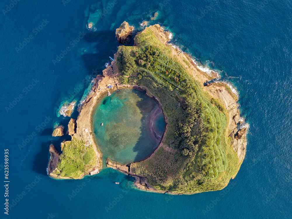 Obraz premium Azores aerial panoramic view. Top view of Islet of Vila Franca do Campo. Crater of an old underwater volcano. Sao Miguel island, Azores, Portugal. Heart carved by nature. Bird eye view.