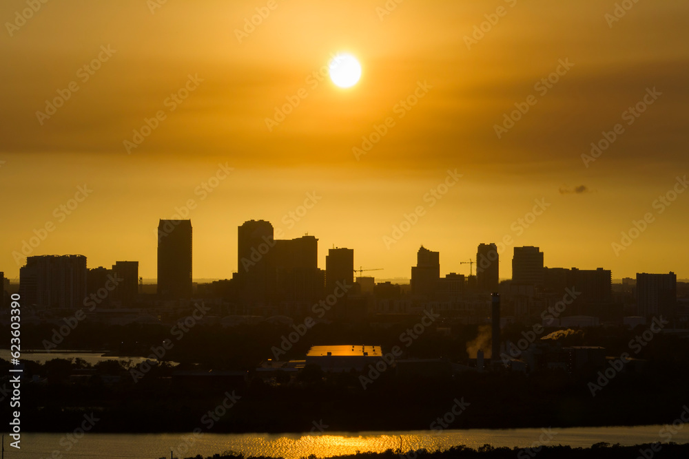 Naklejka premium Aerial view of downtown district of Tampa city in Florida, USA at sunset. Dark silhouette of high skyscraper office buildings in modern american midtown