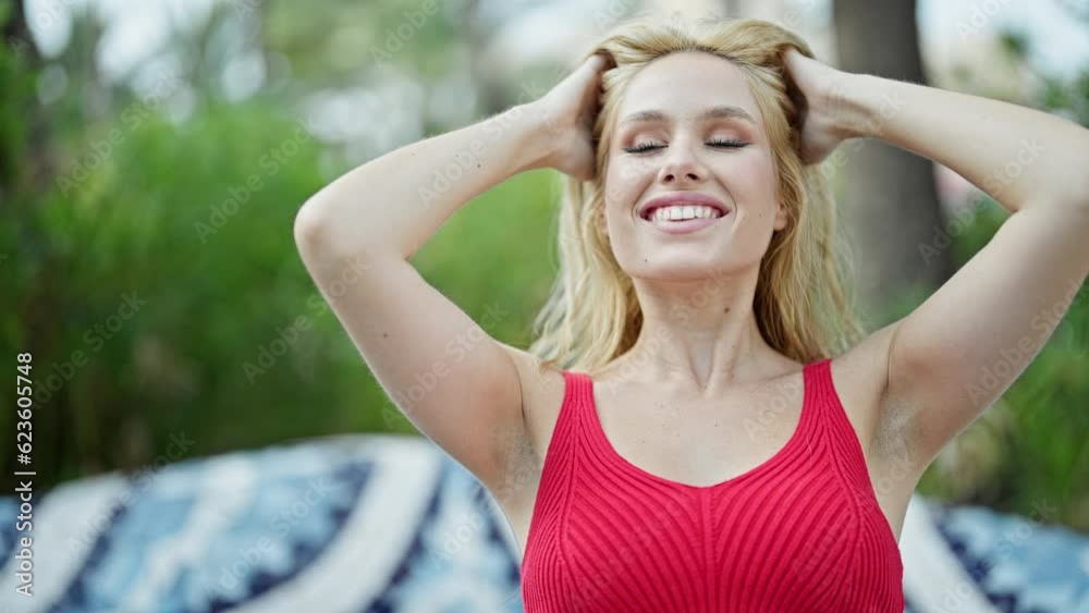 Young blonde woman smiling confident combing hair at park Young blonde woman smiling confident combing hair at park