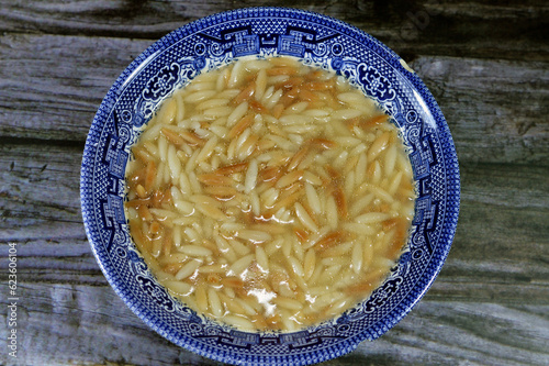 Middle Eastern Orzo Pasta Egyptian soup also known as Shorbet Lesan El Asfour, traditional Egyptian comfort food,  made of Orzo Pasta, Butter, olive oil, broth chicken beef or vegetables, spices, salt photo