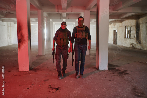 An abandoned building serves as the stronghold for a team of terrorists, fiercely guarding their occupied territory with guns and military equipment © .shock