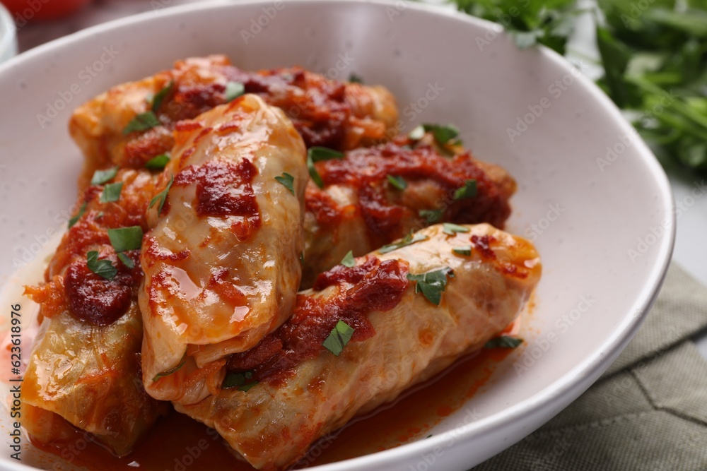 Delicious stuffed cabbage rolls cooked with homemade tomato sauce on table, closeup Delicious stuffed cabbage rolls cooked with homemade tomato sauce on table, closeup