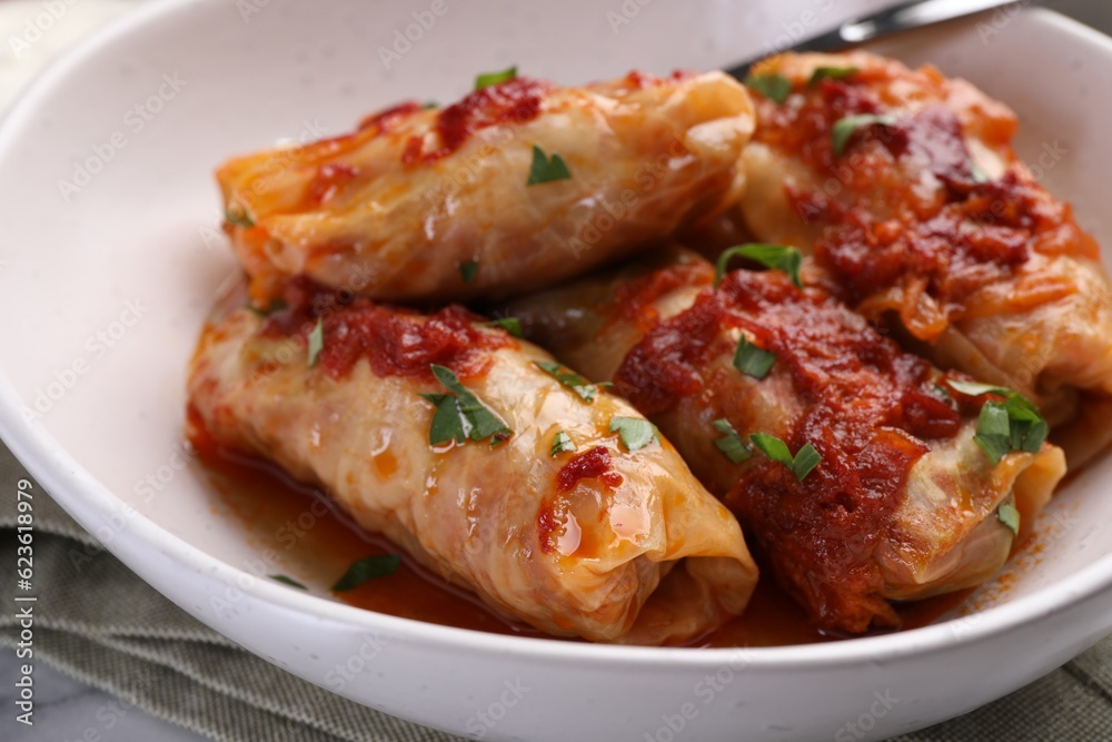Delicious stuffed cabbage rolls cooked with homemade tomato sauce on table, closeup Delicious stuffed cabbage rolls cooked with homemade tomato sauce on table, closeup