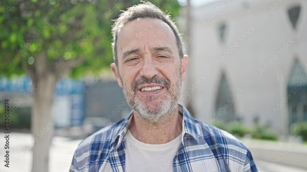 Middle age man smiling confident speaking at park Middle age man smiling confident speaking at park