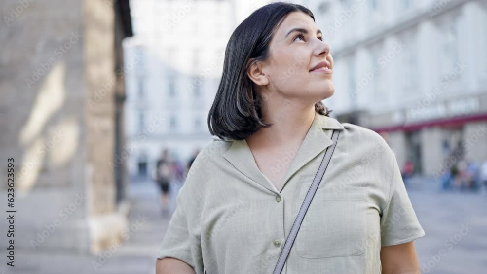 Young beautiful hispanic woman smiling looking around in the streets of Vienna Young beautiful hispanic woman smiling looking around in the streets of Vienna