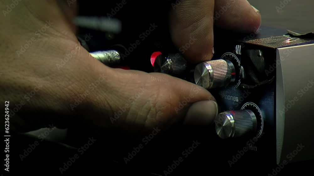 Hands of A Man Using an Old Audiobox USB External Soundboard in Recording Studio. Close Up. 4K Resolution. Hands of A Man Using an Old Audiobox USB External Soundboard in Recording Studio. Close Up. 4K Resolution.