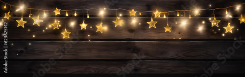 hristmass celebration decoration background banner - Frame made of golden star light chain and bokeh lights on dark black wooden boards wall texture