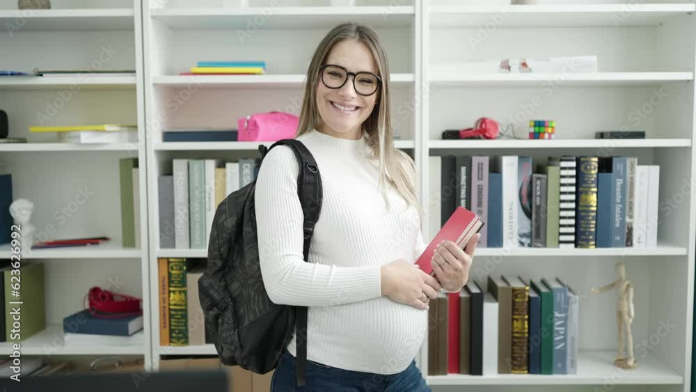 Young pregnant woman student smiling confident holding books at library university Young pregnant woman student smiling confident holding books at library university