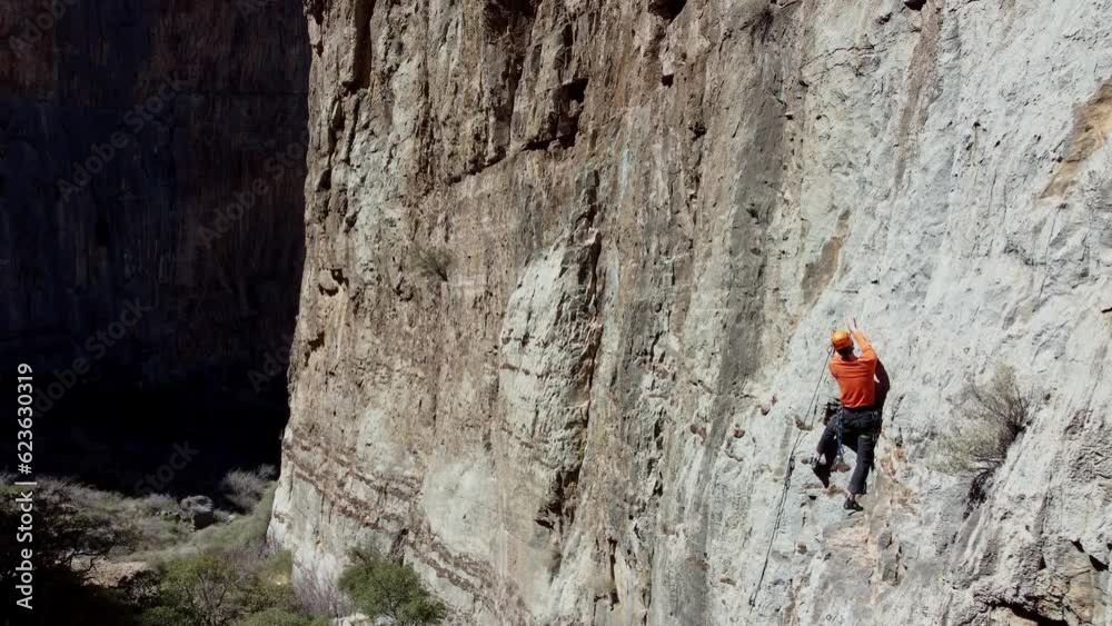 Aerial view of a man doing rock climbing sports Aerial view of a man doing rock climbing sports